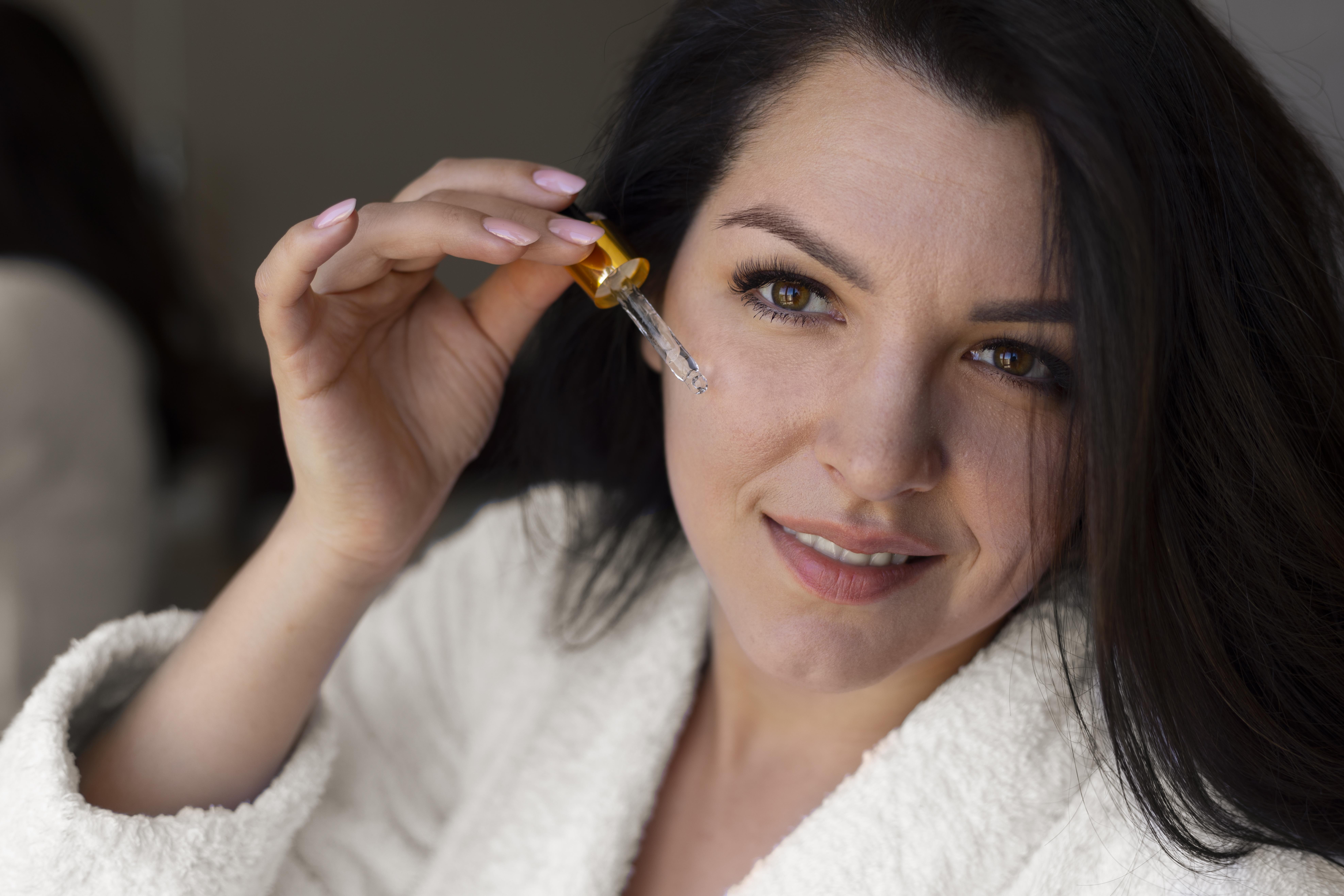 Close Up Woman Applying Face Serum